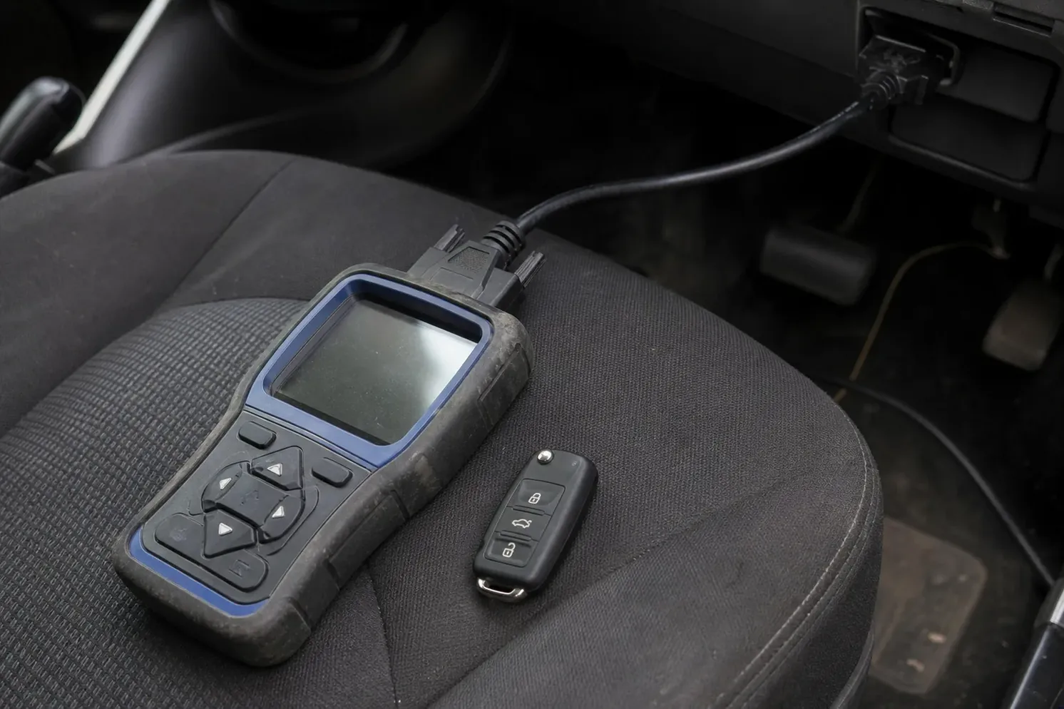 Car key programmer plugged into the OBD port